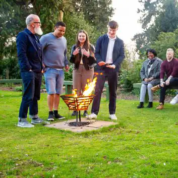 People standing around a fire pit