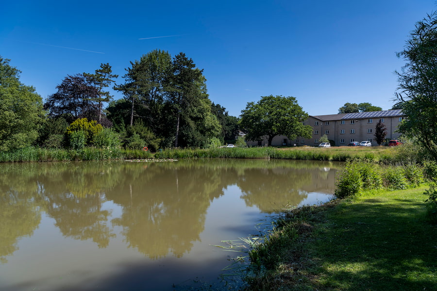 The larger lake at The Hayes with an accomodation building in the background.
