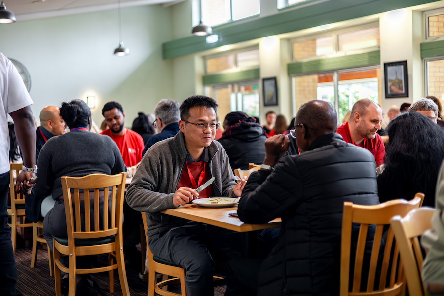 A man enjoying food at lunch time at The Hayes with his team.