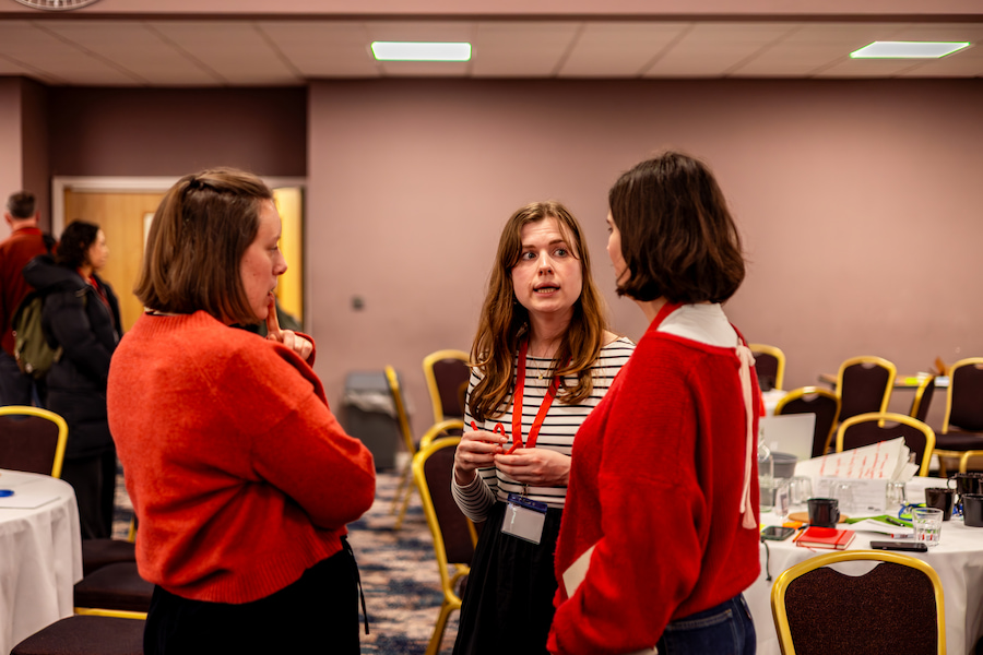 3 women chatting together after a session in the Derbyshire Hall.
