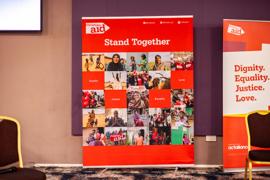 A banner which was one the stage at their event which says, 