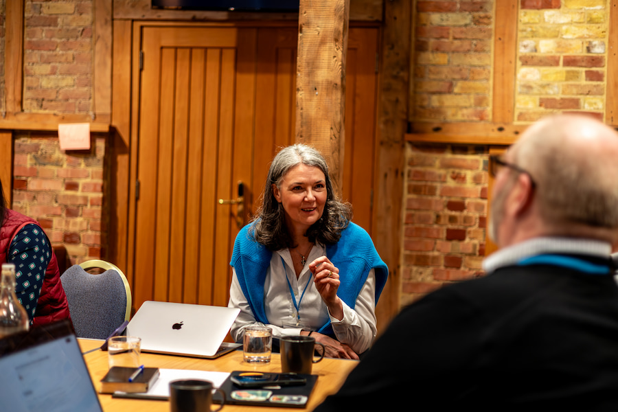 A woman telling a story to 2 other trustees in the Chapel Barn at High Leigh.
