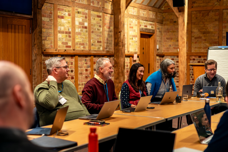 Chris Gillies laughing with the rest of the board during their meeting in the Chapel Barn at High Leigh.