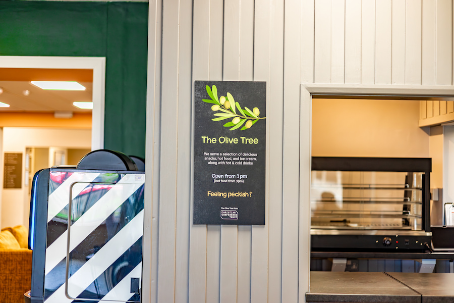 A close up of The Olive Tree sign.