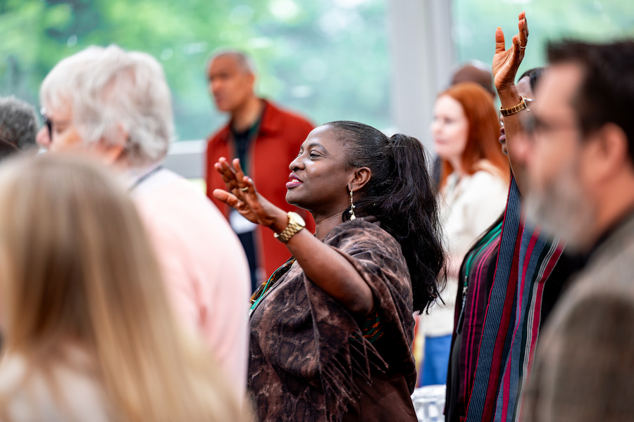 A woman worshipping with her group.