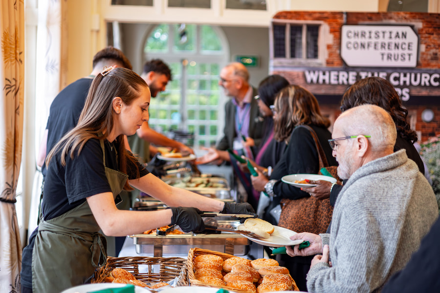 A member of staff serving a guest food.