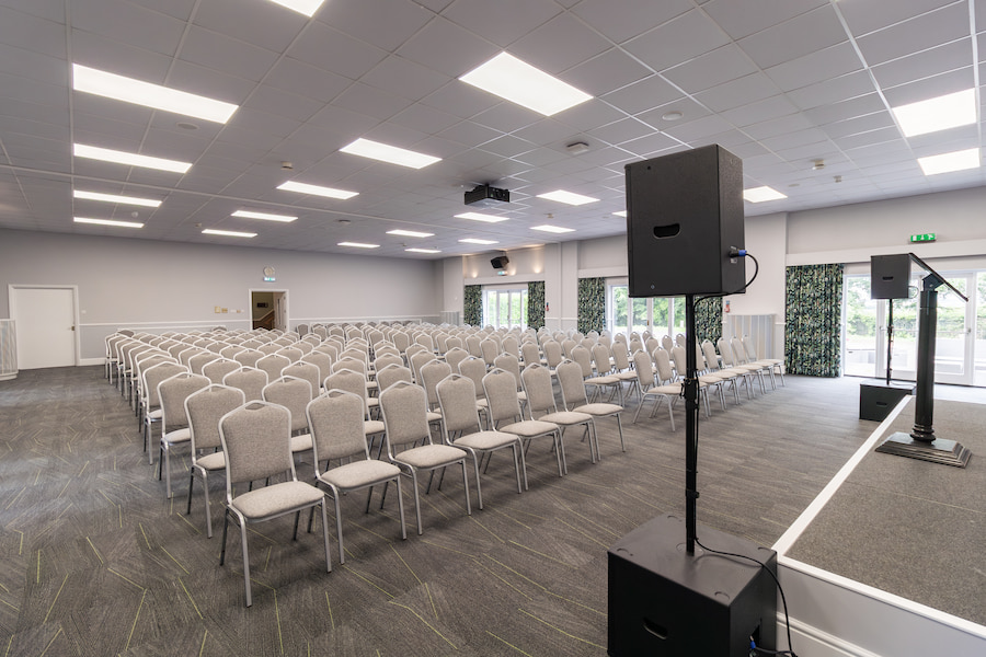 Aspen Hall from the front showing the speaker system and chairs set out in theatre style.