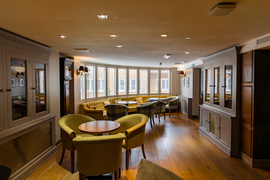 Another perspective of the Bar Lounge with a curved window and booth seating that follows the window.