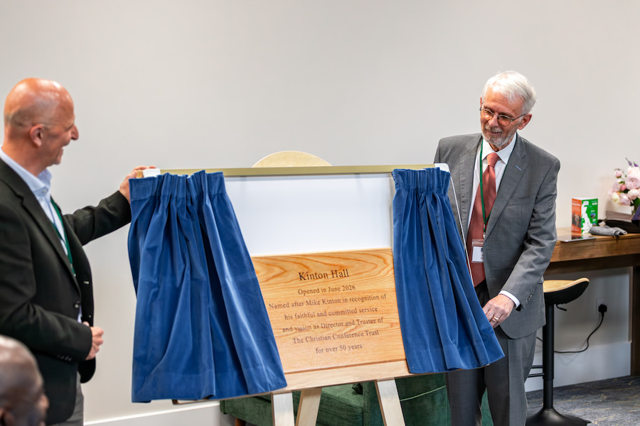 An image of Mike Kinton revealing the plaque commemorating the opening of Kinton Hall.