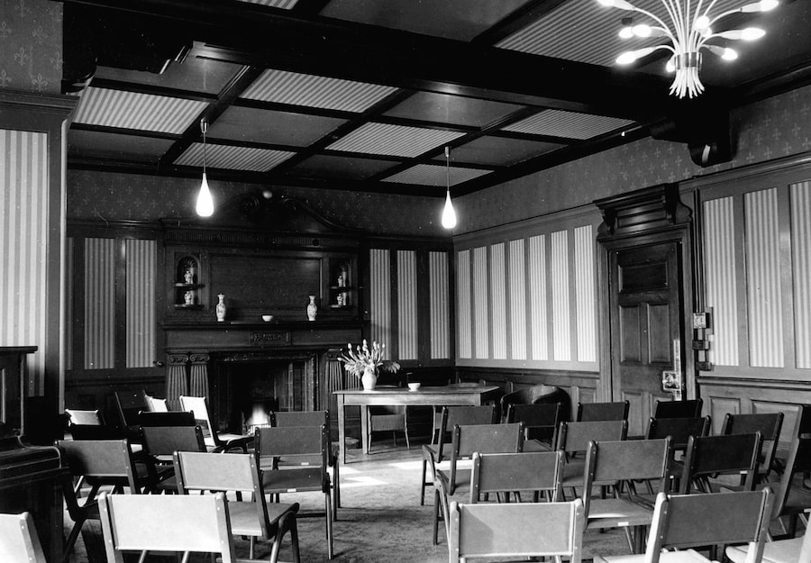 The Boardroom in 1950 set up with chairs facing the fireplace.