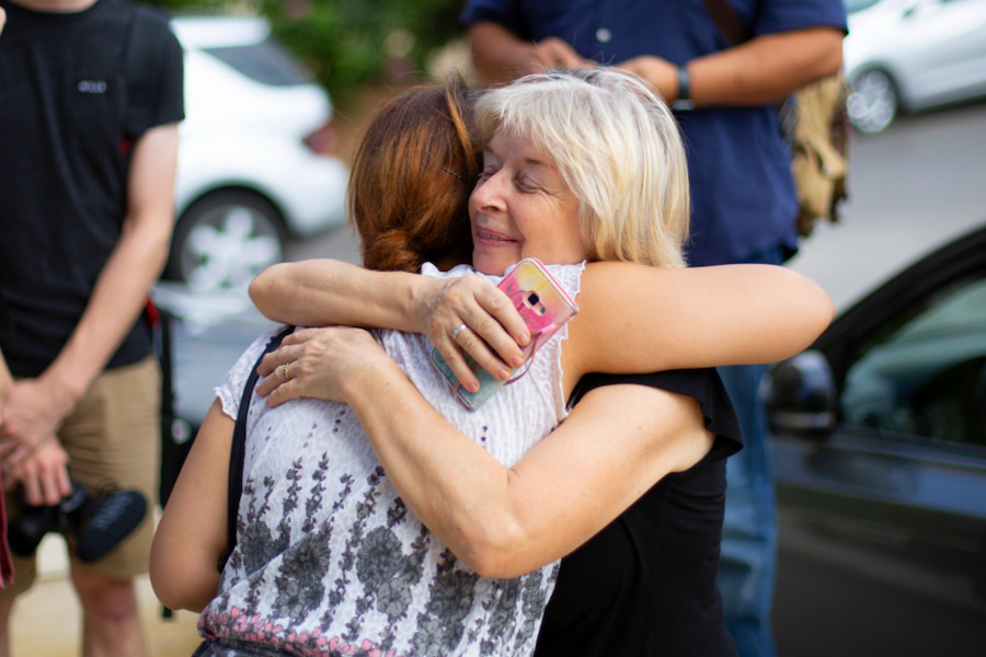 Two women embracing in a loving way during the conference at Highgate House.