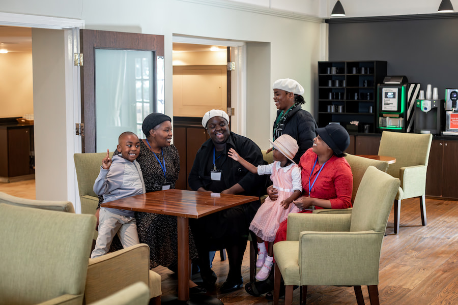 A group of young and old delegates laughing together and hanging out.