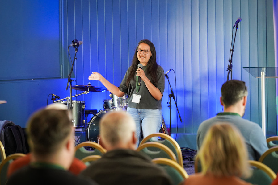 A woman speaking at the front.