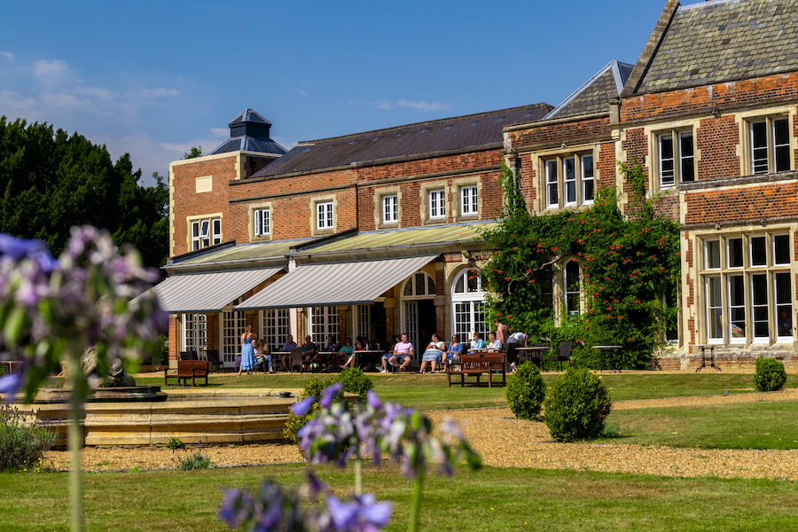 People fellowshipping outside in the sun at High Leigh.