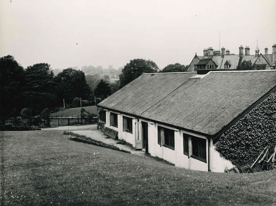 The Main Conference Hall in the 1920s with a view of The Hayes main house in the background and much less trees and bushes.