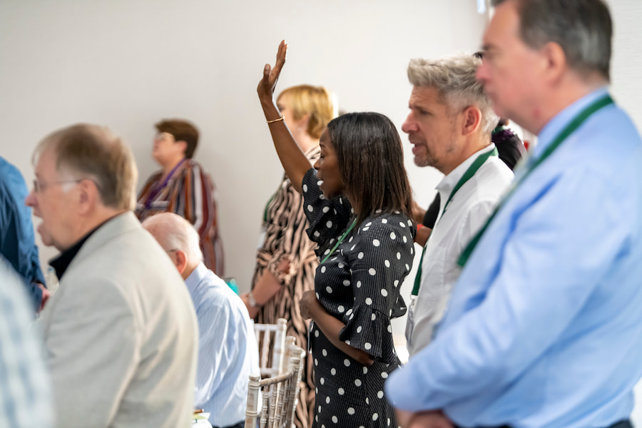 A woman worshipping at a conference at one of our conference venues.