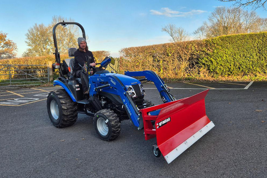 The Hayes' gardener sitting on the new tractor.