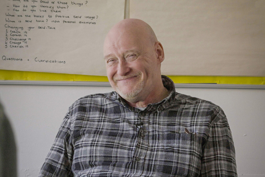James in his current position smiling.
