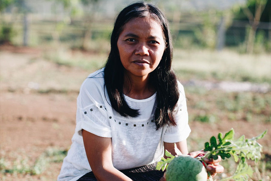 A missionary woman helping farmers in a foreign country.